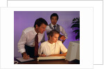 Business people working together at desktop computer by Anonymous
