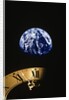 Earth and clock face at 11:57 by Anonymous