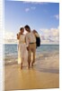 1980s 1990s couple walking on beach by Anonymous