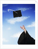 Graduate tossing mortarboard hat into the air by Anonymous
