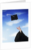 Graduate tossing mortarboard hat into the air by Anonymous