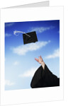 Graduate tossing mortarboard hat into the air by Anonymous