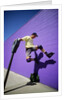 Boy Wearing Roller Blades Jumping Against Wall by Anonymous