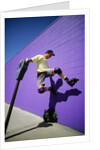 Boy Wearing Roller Blades Jumping Against Wall by Anonymous
