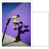 Boy Wearing Roller Blades Jumping Against Wall by Anonymous