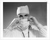 1960s male doctor wearing surgical mask and operating room scrubs by Anonymous