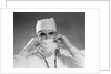 1960s male doctor wearing surgical mask and operating room scrubs by Anonymous