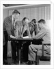1950s group of businessmen looking at a blueprint on a table by Anonymous