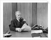 1930s senior executive speaking into a dictaphone by Anonymous