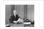 1930s senior executive speaking into a dictaphone by Anonymous