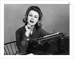 1960s smiling secretary with a typewriter by Anonymous