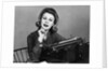 1960s smiling secretary with a typewriter by Anonymous