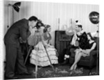 1940s photographer taking picture of young people at New Years party by Anonymous