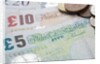 Paper money with change on a table by Anonymous