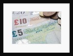 Paper money with change on a table by Anonymous