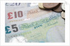 Paper money with change on a table by Anonymous
