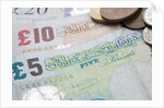 Paper money with change on a table by Anonymous