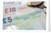 Paper money with change on a table by Anonymous