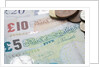 Paper money with change on a table by Anonymous