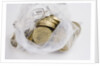 Looking down into an open money bag of pound coins by Anonymous