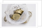 Looking down into an open money bag of pound coins by Anonymous