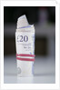 A roll of twenty pound notes on a table by Anonymous