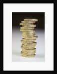 A pile of pound coins on a table by Anonymous