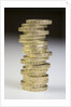 A pile of pound coins on a table by Anonymous