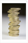 A pile of pound coins on a table by Anonymous