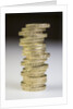 A pile of pound coins on a table by Anonymous