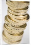 A pile of pound coins on a table by Anonymous