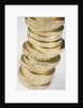 A pile of pound coins on a table by Anonymous