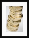 A pile of pound coins on a table by Anonymous