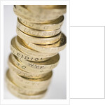 A pile of pound coins on a table by Anonymous