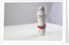 A roll of twenty pound notes on a table by Anonymous