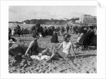 1920s two women sitting on the beach in bathing suits by Anonymous