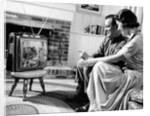 1950s couple watching television by Anonymous