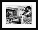 1950s couple watching television by Anonymous