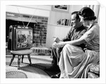 1950s couple watching television by Anonymous