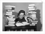 1950s portrait of woman sitting with stacks of books by Anonymous