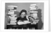 1950s portrait of woman sitting with stacks of books by Anonymous