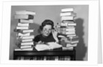 1950s portrait of woman sitting with stacks of books by Anonymous