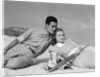 1930s couple lying on a beach by Anonymous
