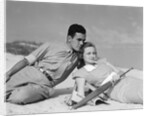 1930s couple lying on a beach by Anonymous