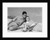 1930s couple lying on a beach by Anonymous