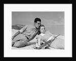 1930s couple lying on a beach by Anonymous