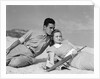 1930s couple lying on a beach by Anonymous