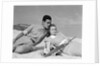 1930s couple lying on a beach by Anonymous