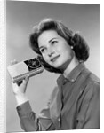 1960s smiling teenage girl listening to portable radio by Anonymous