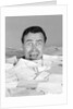 1960s portrait of bug-eyed man buried by bills by Anonymous